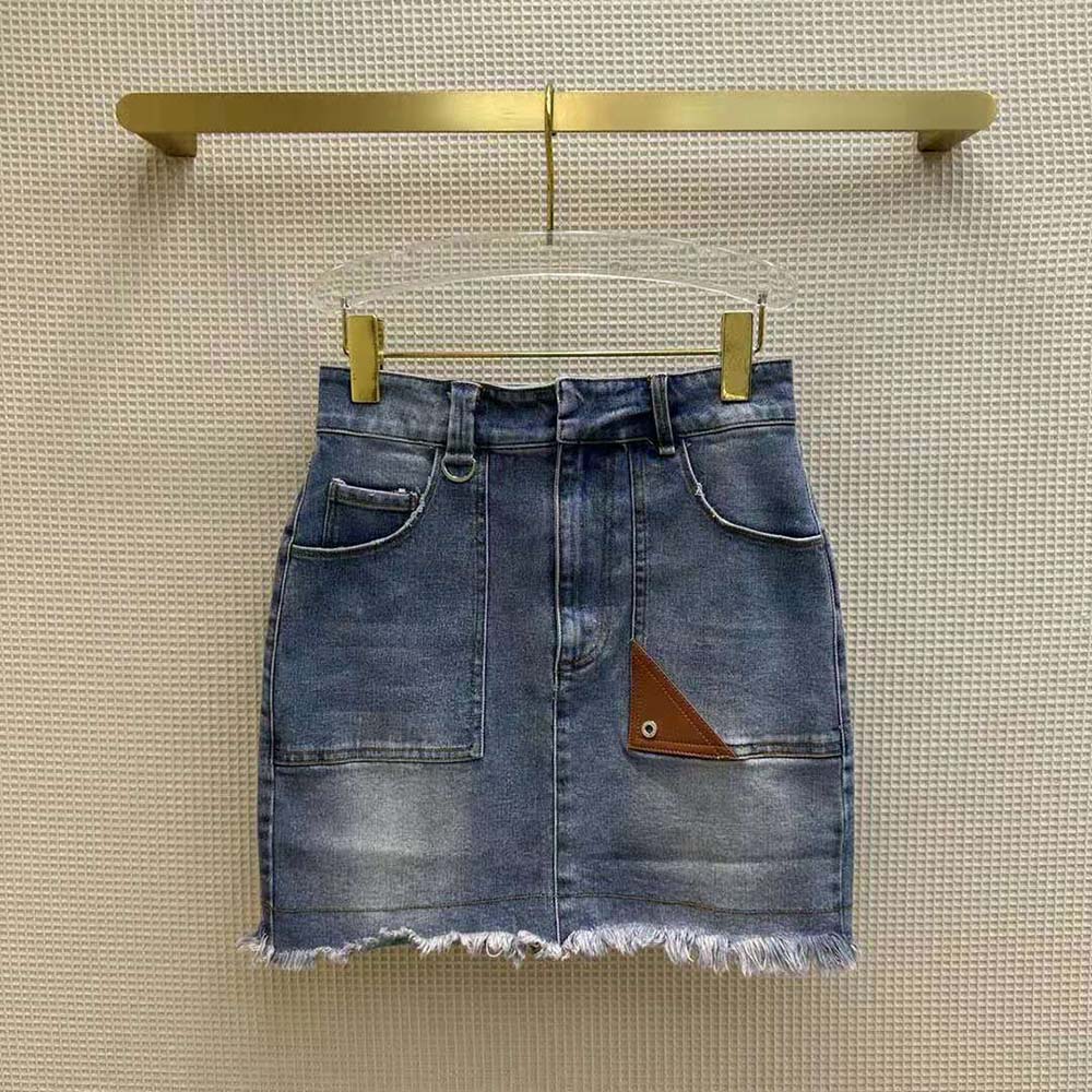 Close-up of branded button and rivet on Fendi denim skirt