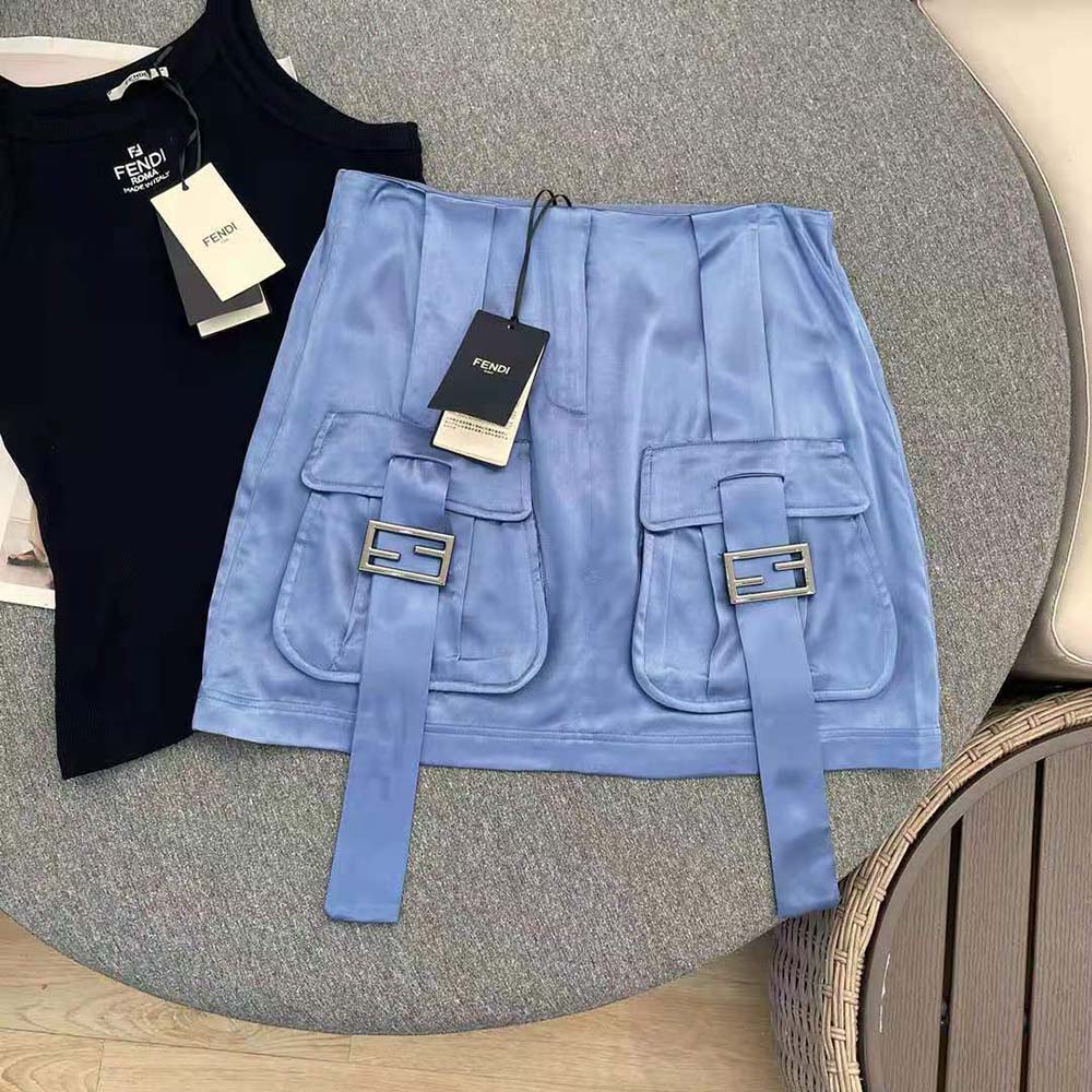Close-up of smooth satin fabric and Fendi logo hardware on skirt