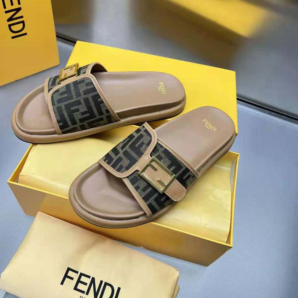 Close-up of Fendi logo detail on brown fabric slide upper