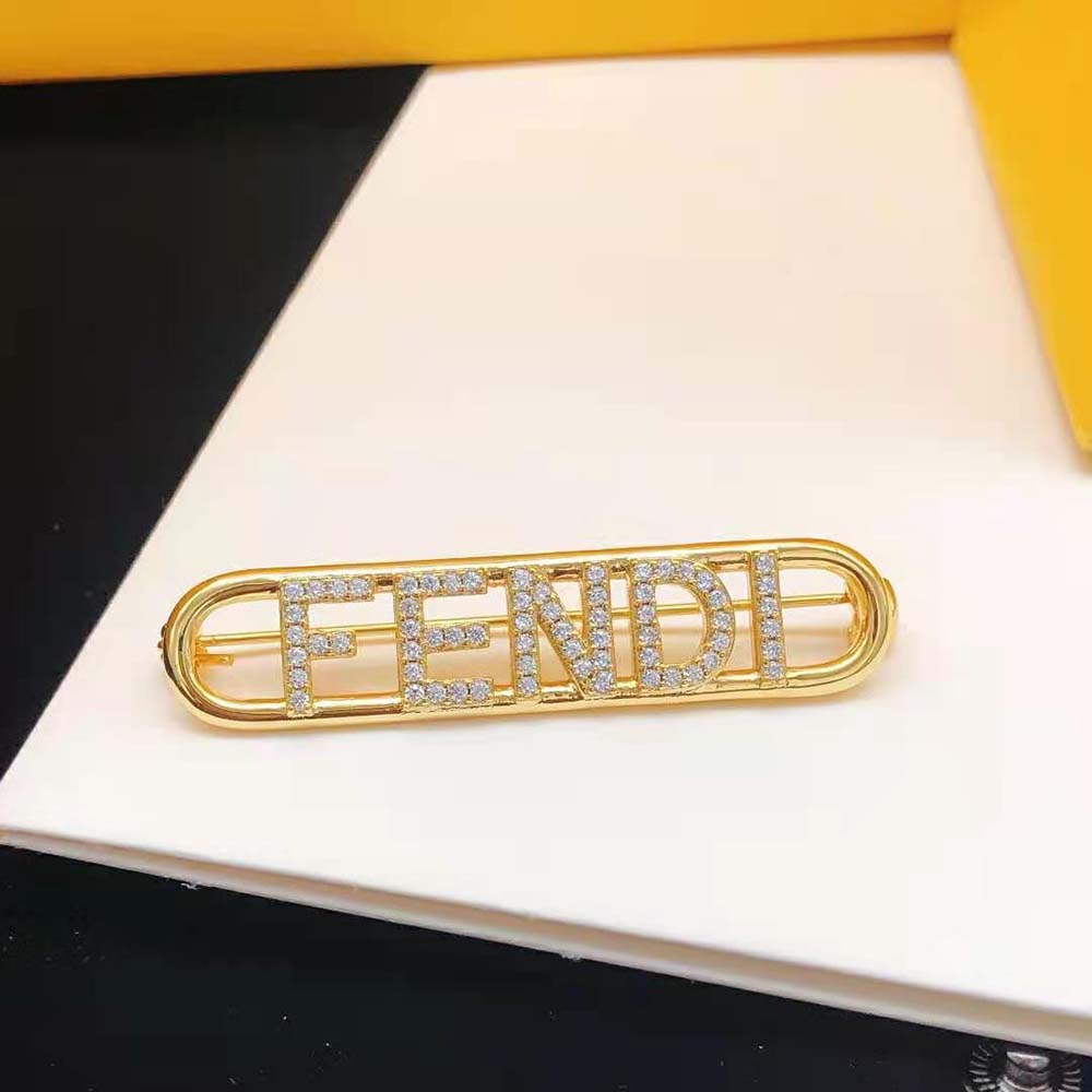 Side angle of Fendi Women Fendigraphy Brooch Gold Coloured highlighting pin closure