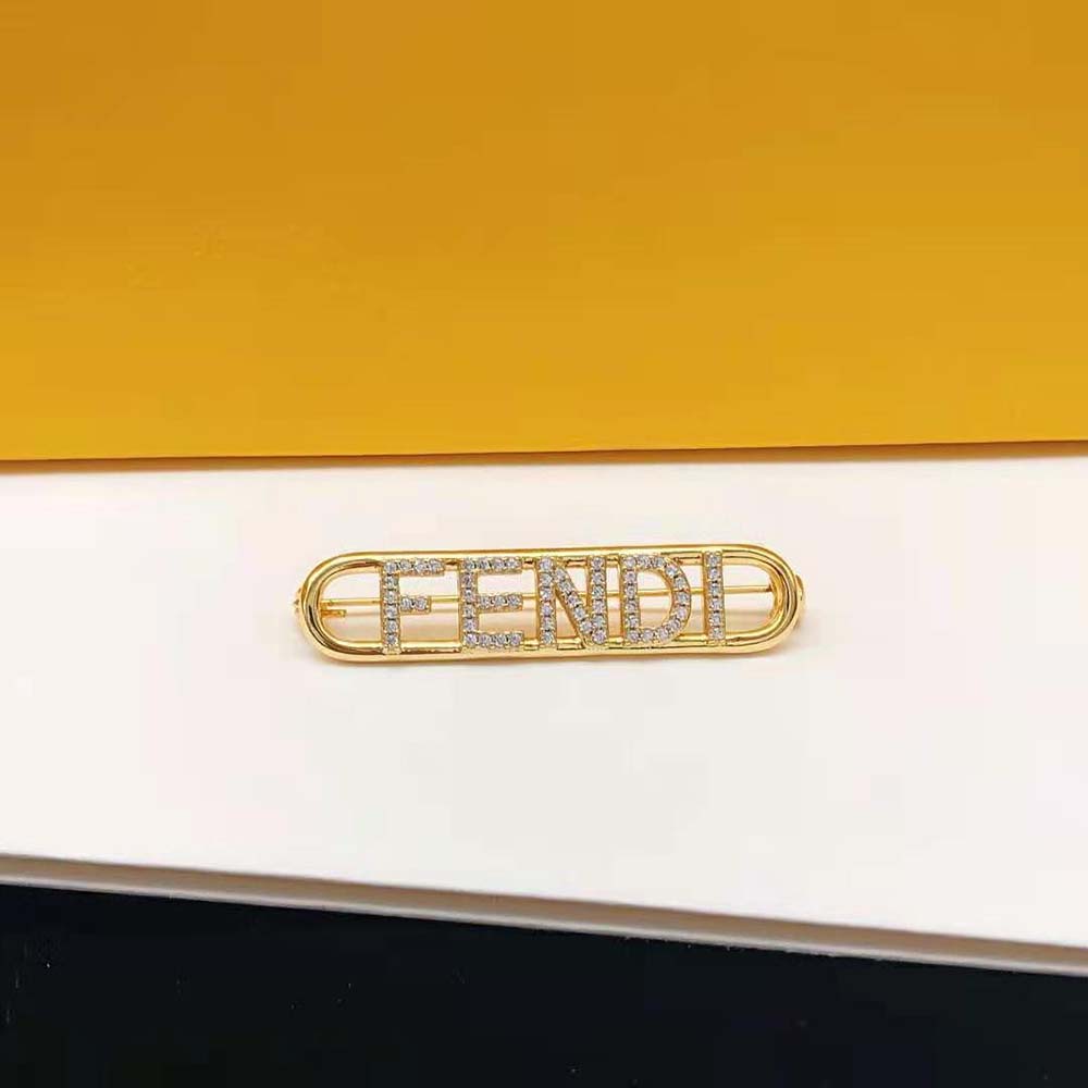 Styled view of Fendi Women Fendigraphy Brooch Gold Coloured pinned on blazer lapel