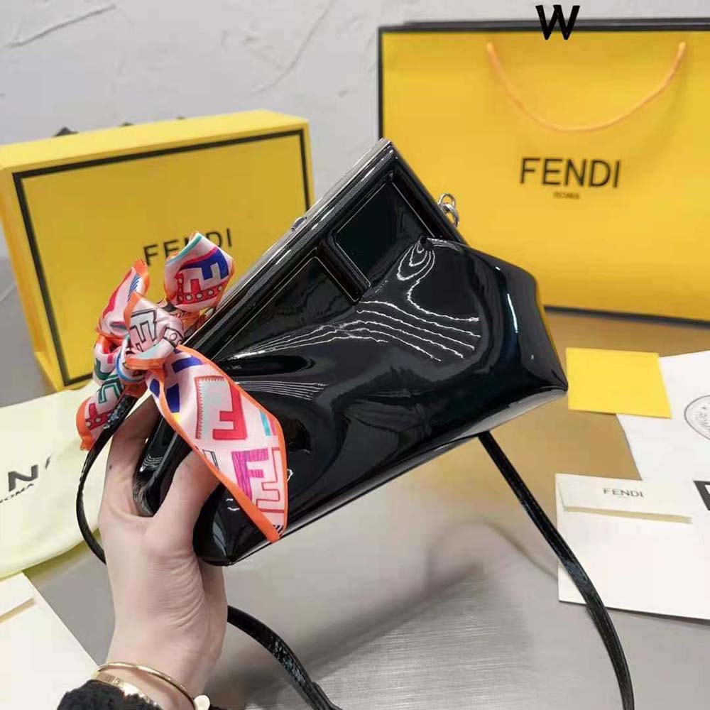 Side profile showing smooth magnetic flap of Fendi Women First Midi Black Patent Leather Bag