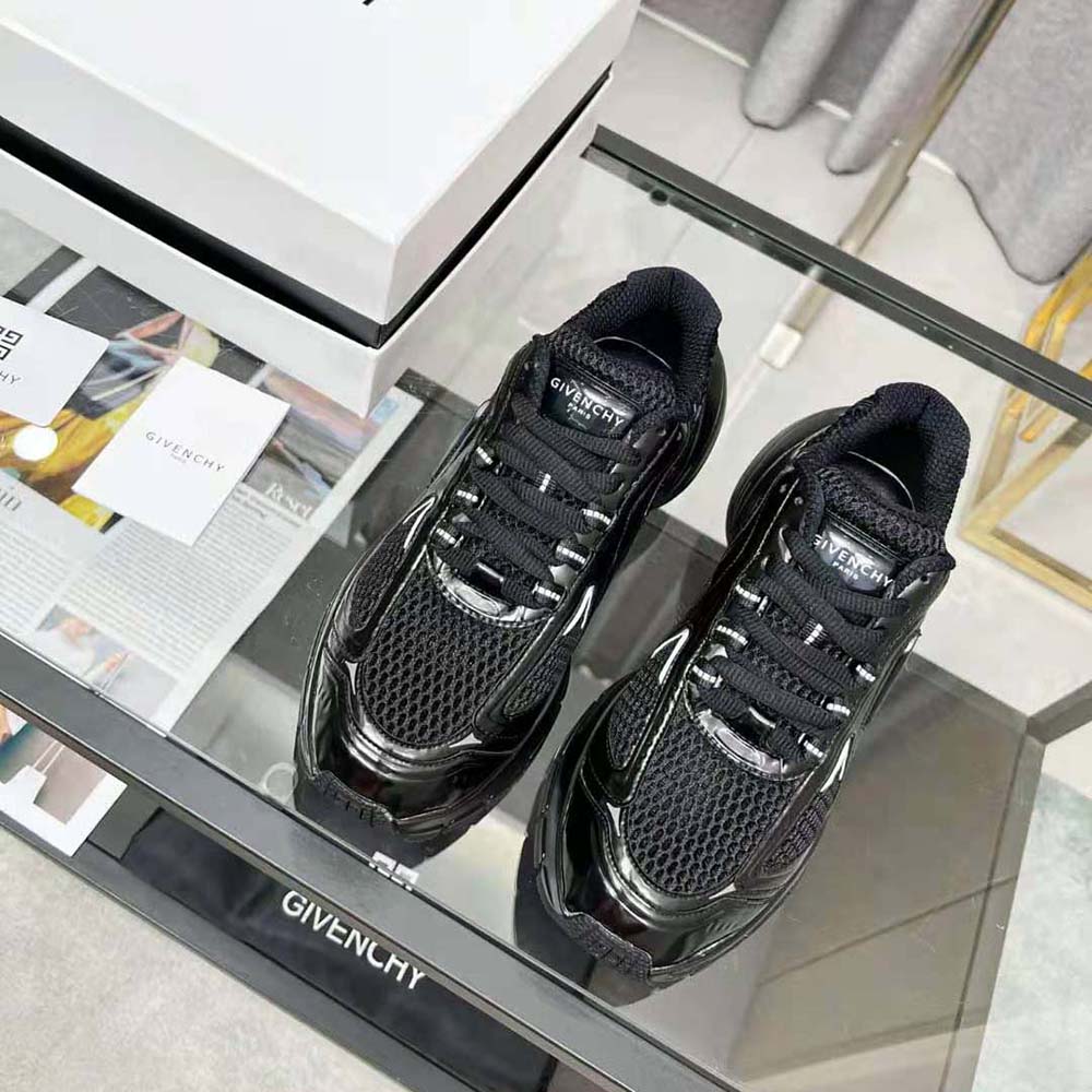 Close-up of black mesh and Givenchy logo hardware on TK-MX Runner Sneakers