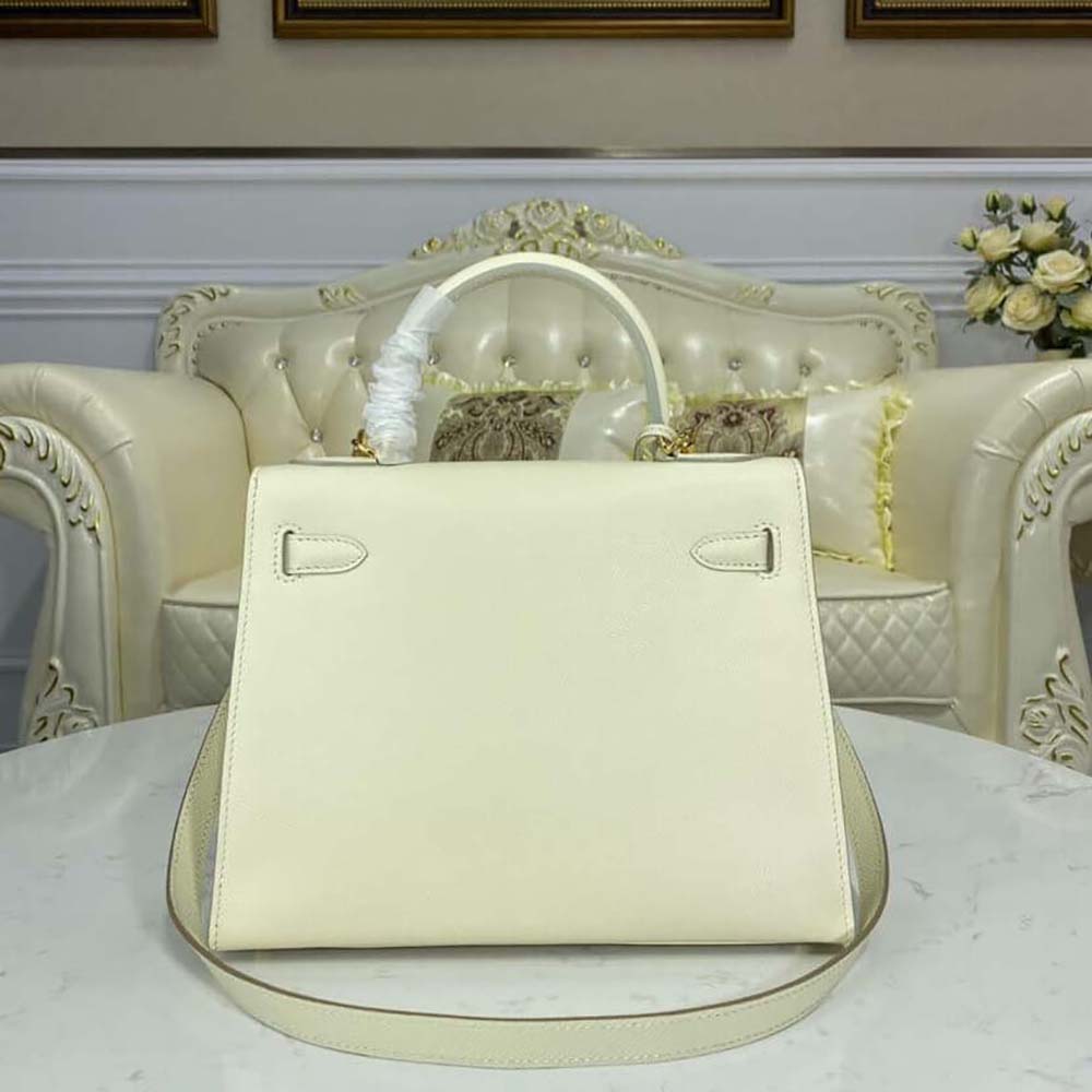 Side angle showing the elegant silhouette of Hermes Women Kelly Bag 28 White