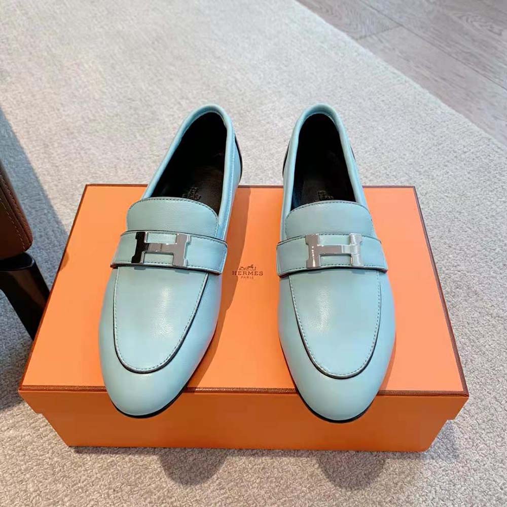 Close-up of blue calfskin and signature palladium-plated “H” on loafer