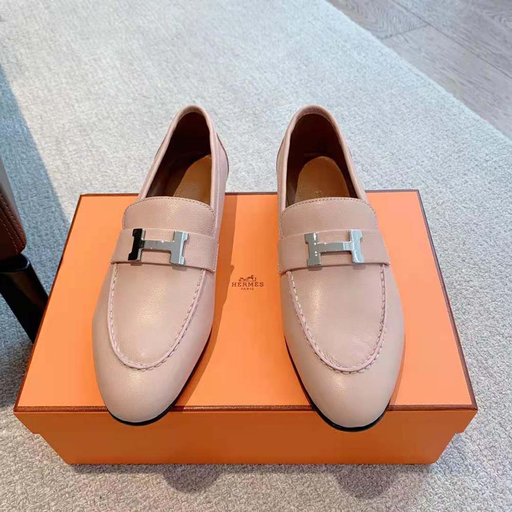 Close-up of palladium-plated signature “H” detail on pink loafer