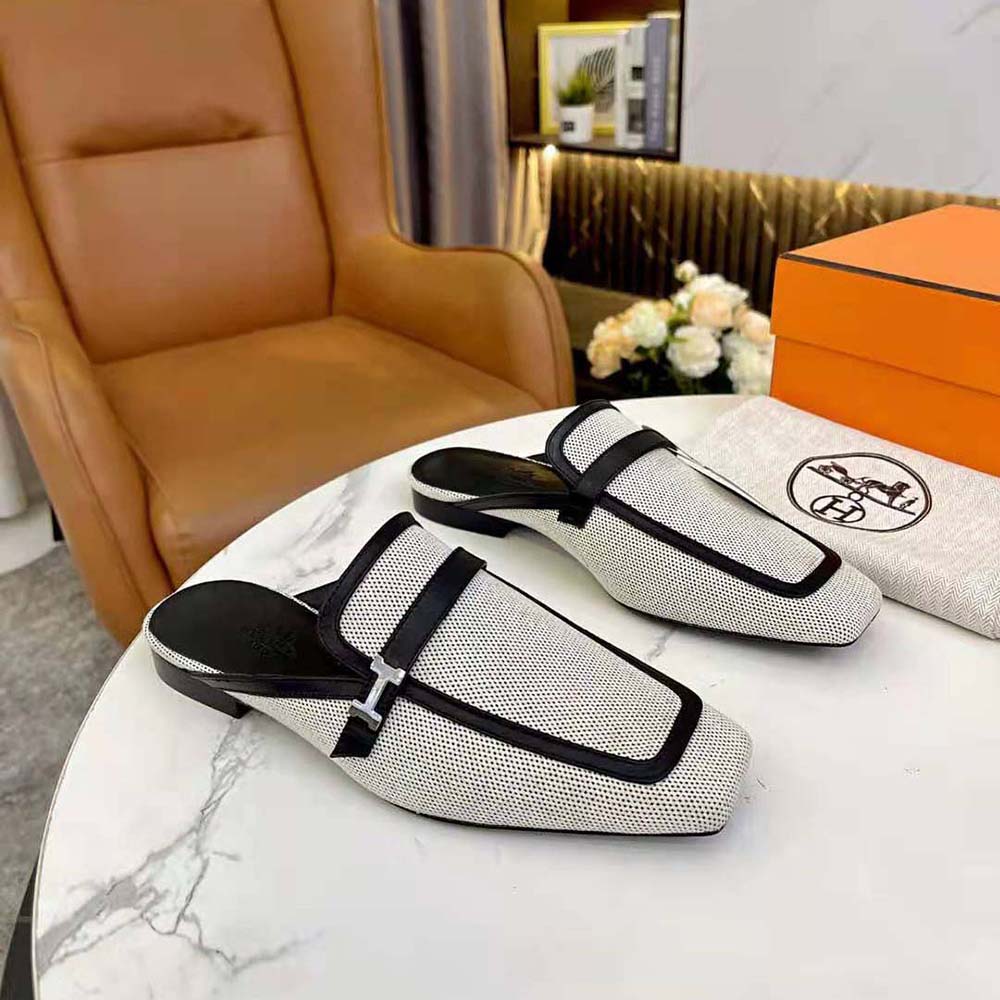 Top angle showing black calfskin and canvas on Hermes Women in H sandal