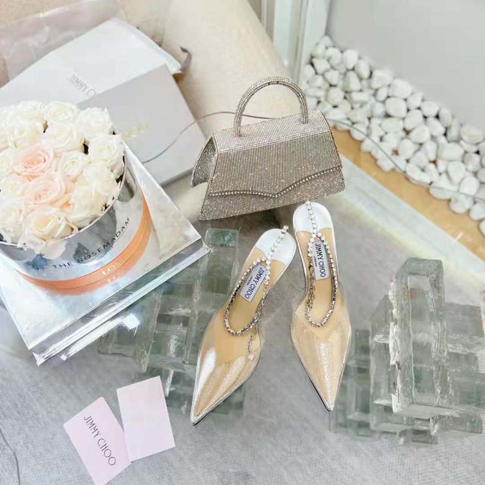 Close-up of crystal embellishment on Jimmy Choo Saeda 100 Silver Glitter Plexi Pumps
