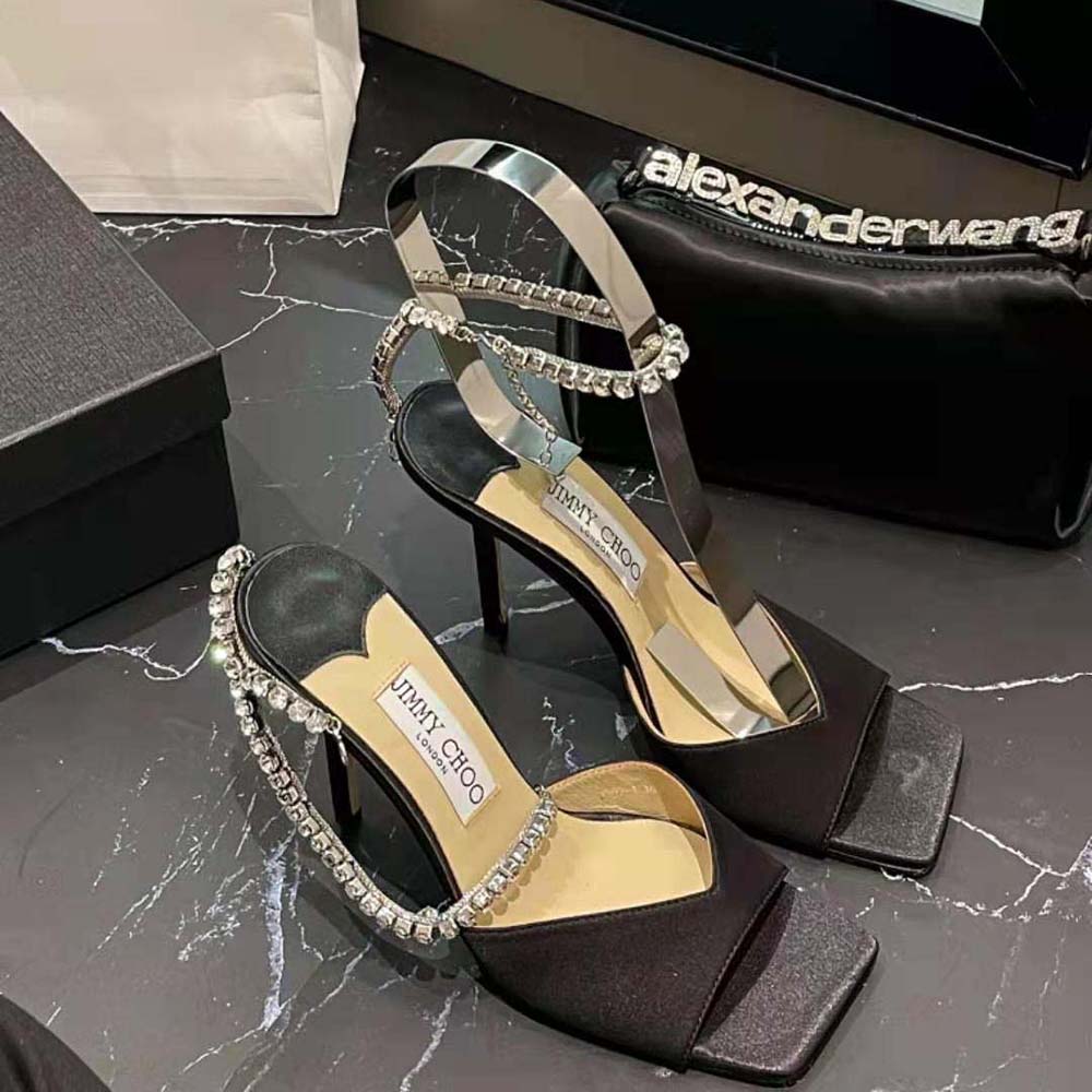Rear angle showing ankle buckle on Jimmy Choo Women Saeda Sandal 100 Black Suede