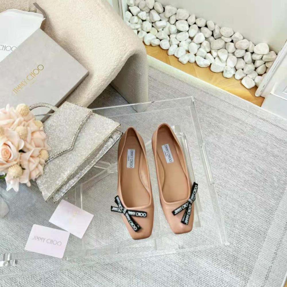 Close-up of signature Jimmy Choo grosgrain bow on pink leather ballet flats