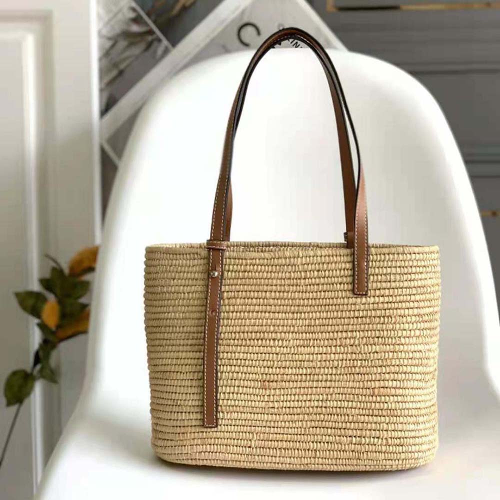 Side angle showing woven raffia and leather contrast on Loewe Small Square Basket Bag