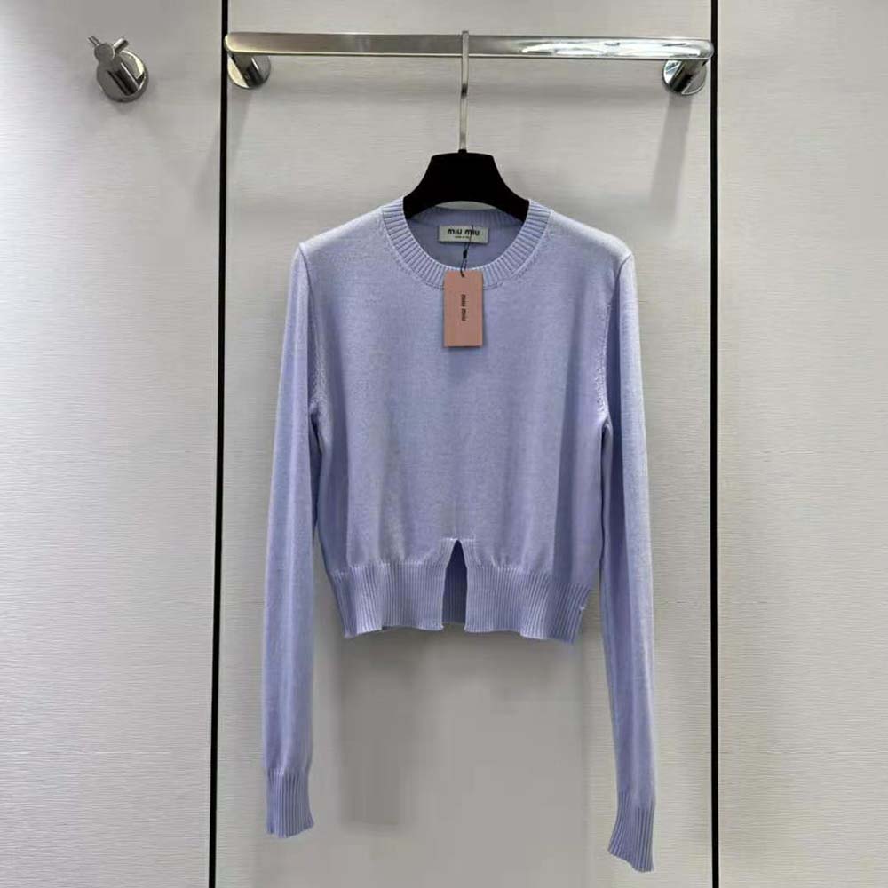 Close-up of soft cashmere fabric on Miu Miu blue sweater