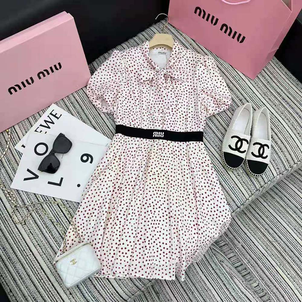 Close-up of pink silk crepe and heart print on Miu Miu mini-dress
