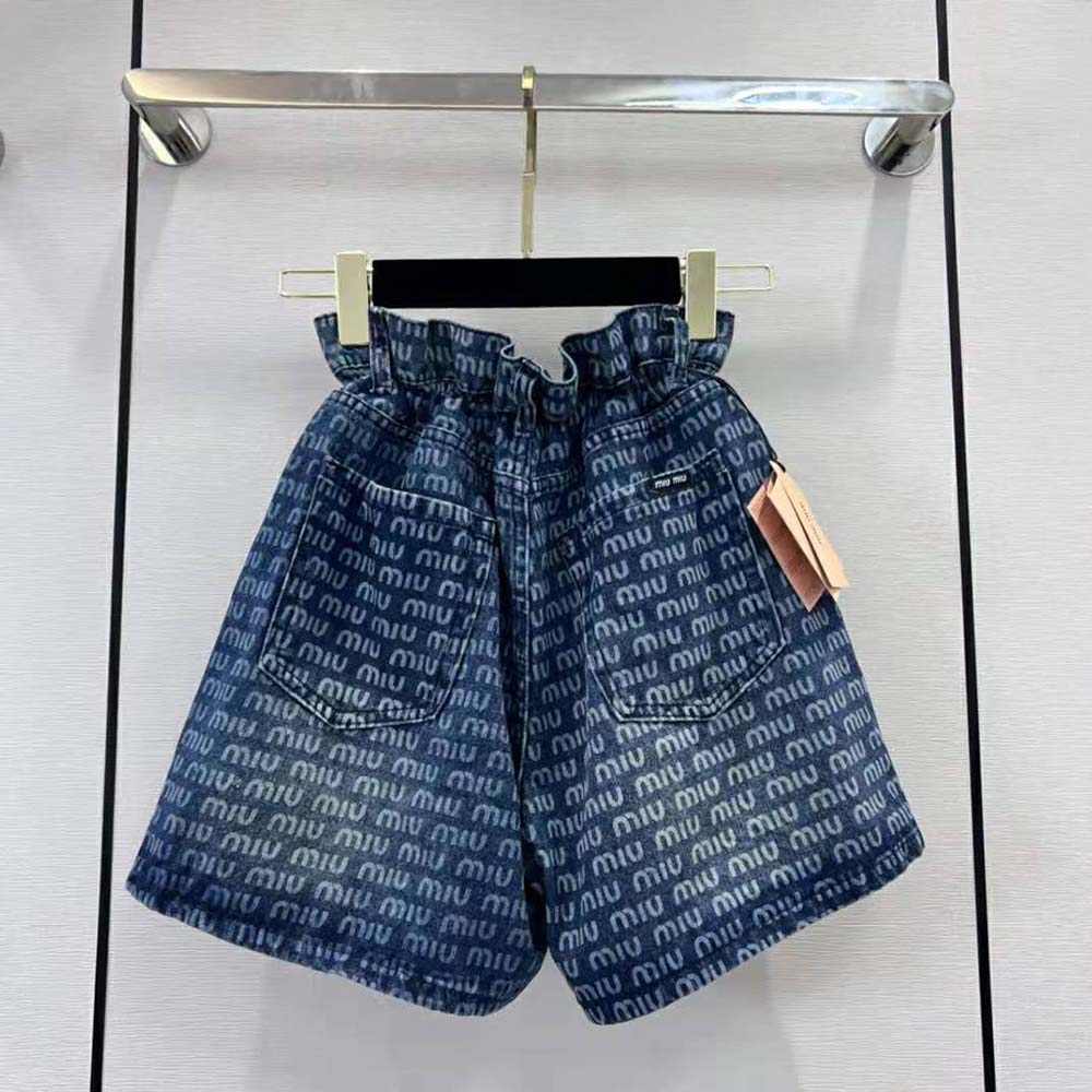 Close-up of coin pocket and silver-tone hardware on Miu Miu denim shorts