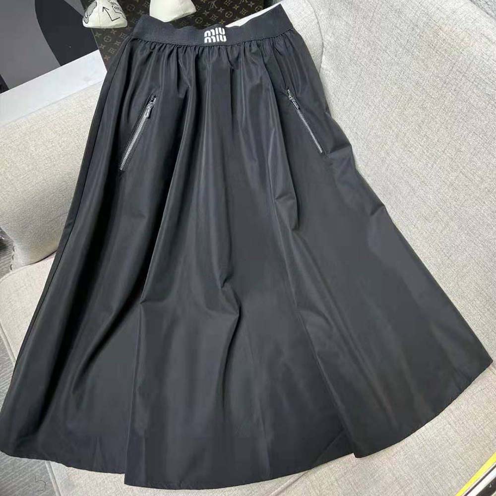 Close-up detail of black technical silk fabric on Miu Miu skirt