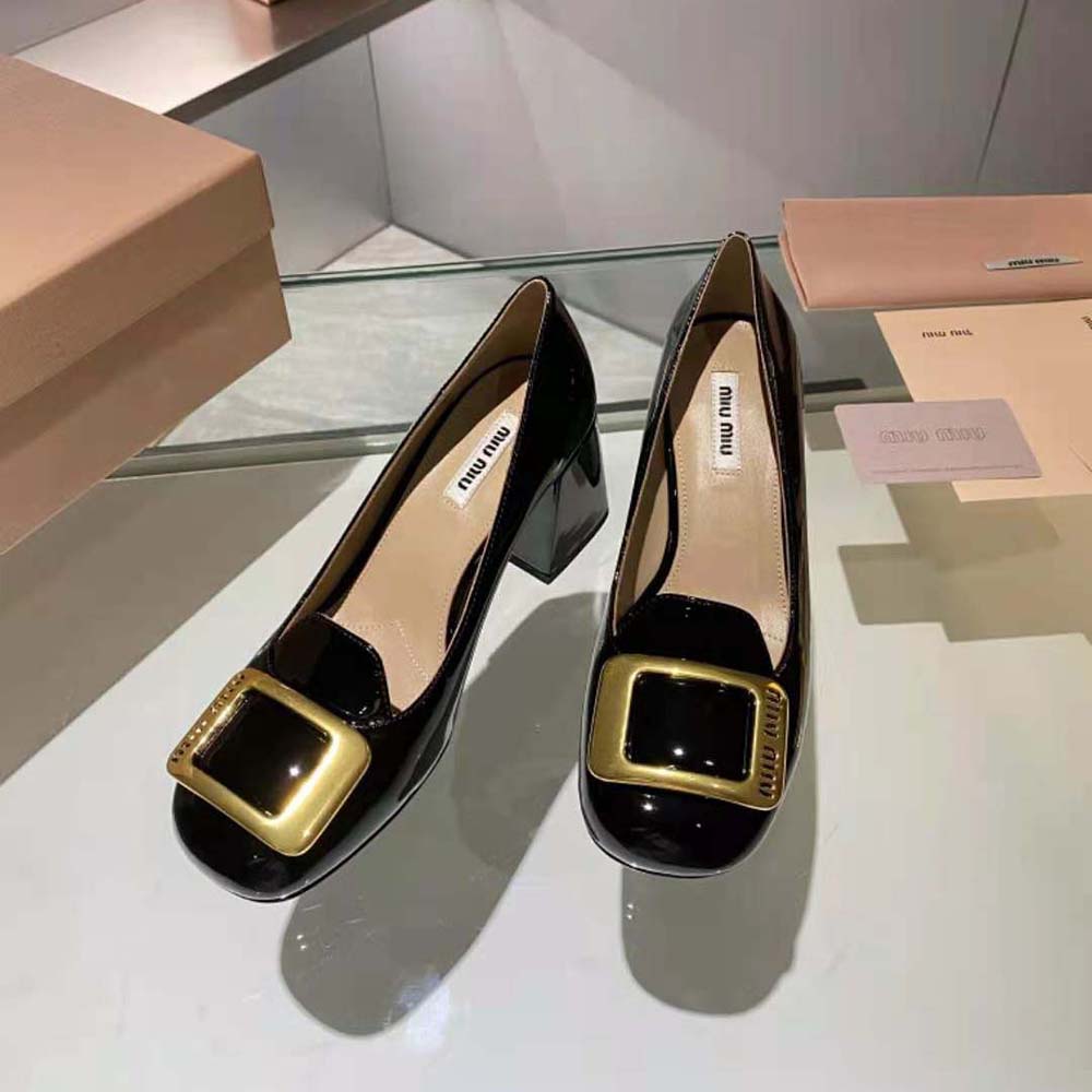 Top-down angle showing glossy patent leather finish of Miu Miu pumps