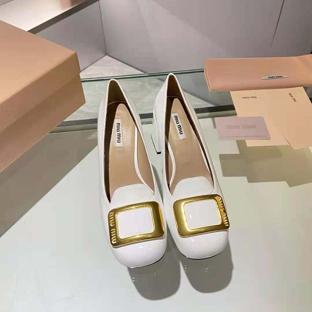 Close-up of glossy patent leather and pointed toe on Miu Miu pumps