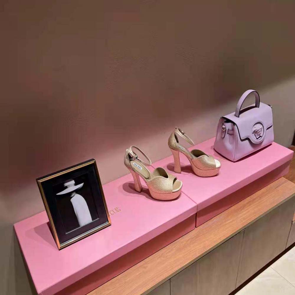 Close-up detail of crystal embellishments on Miu Miu satin platform sandals