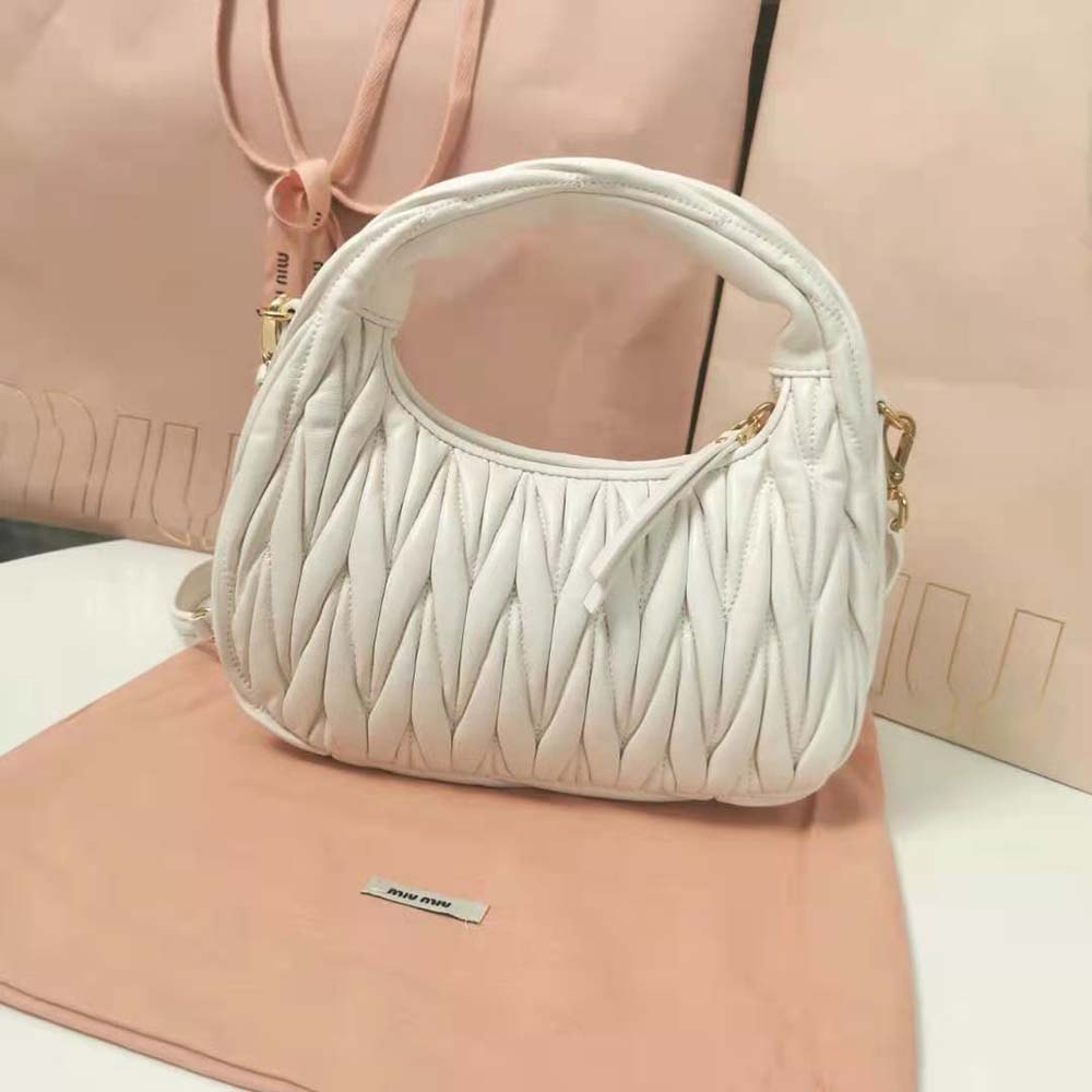 Side angle showing curved silhouette of Miu Miu Women Wander Matelassé Nappa Leather Hobo Bag-White