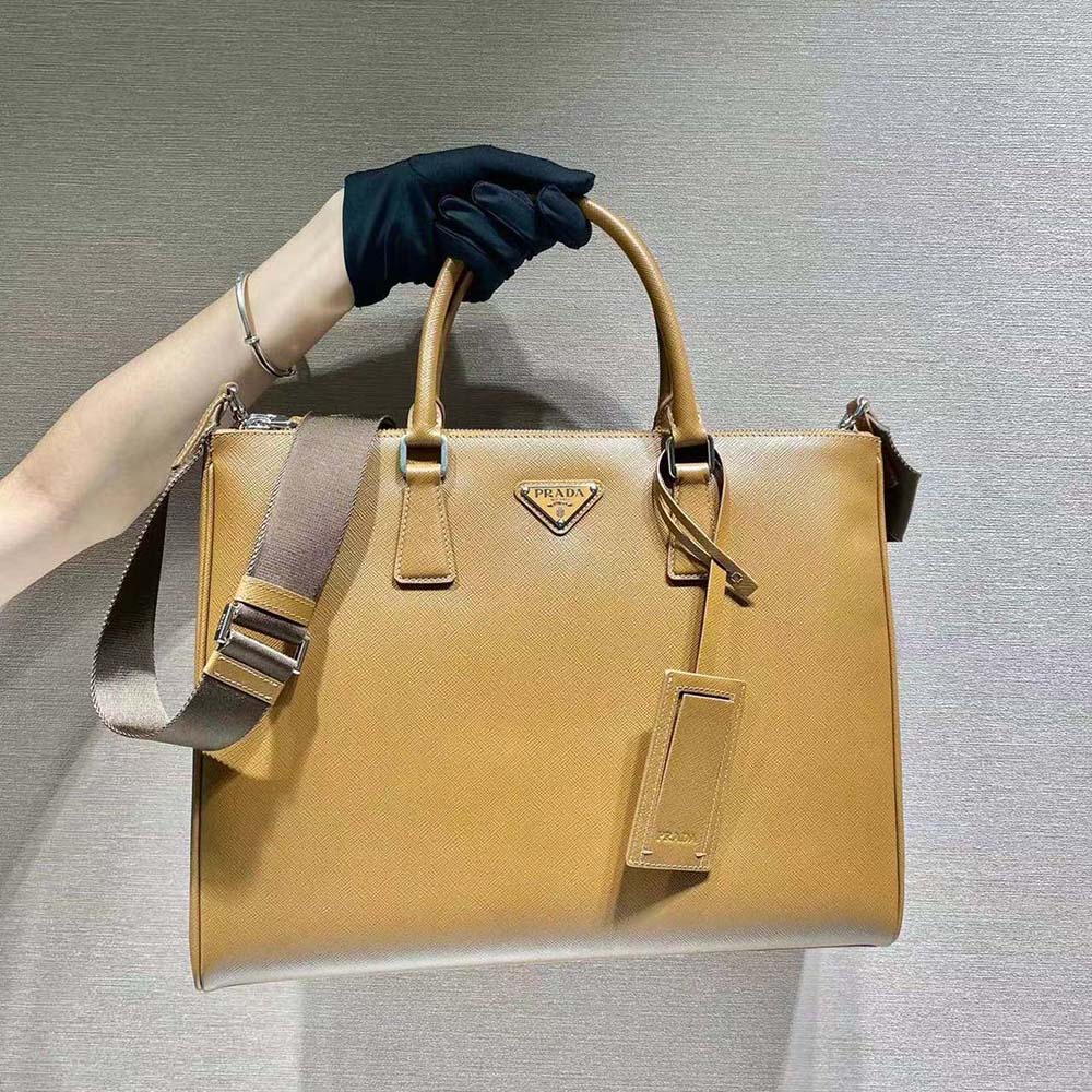 Close-up of brown saffiano leather texture and silver Prada logo hardware