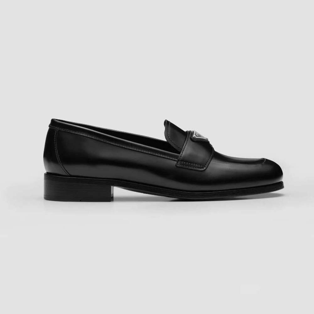 Side angle of Prada Women Brushed Leather Loafers-Black showing sleek silhouette