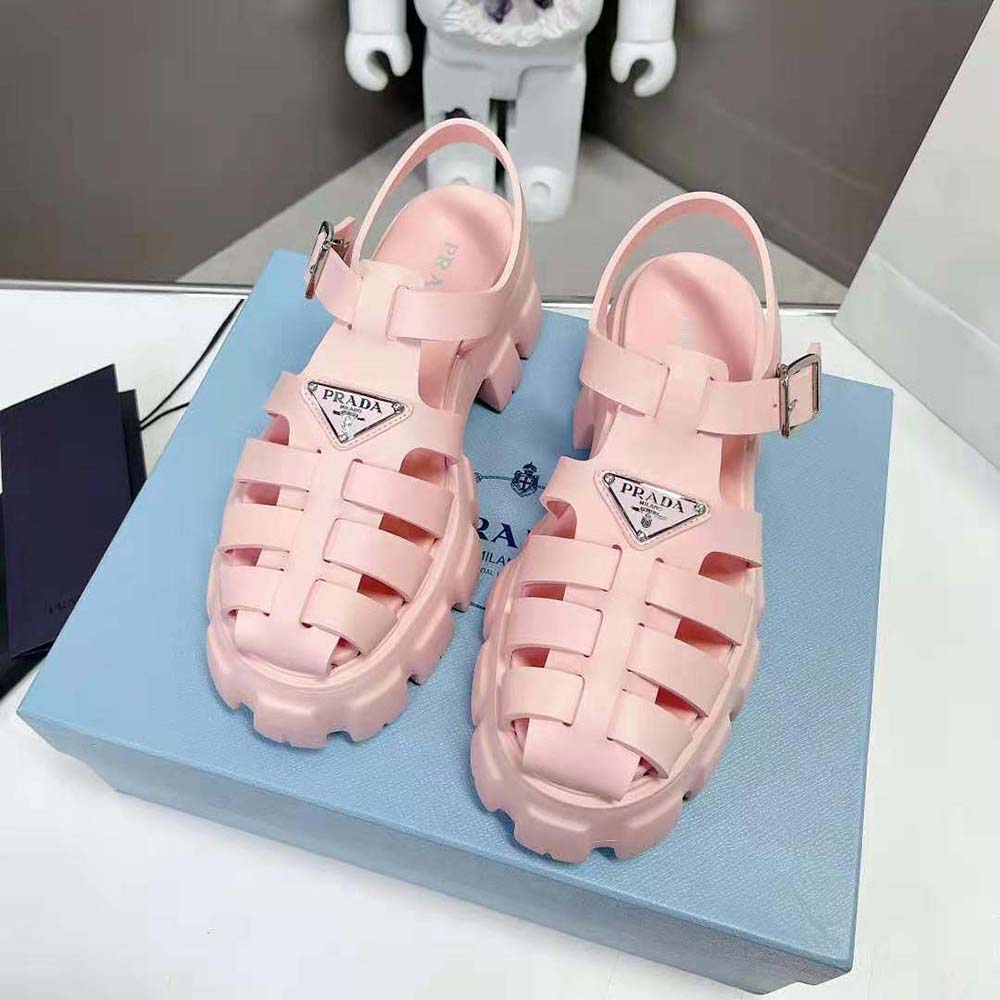 Close-up of enameled metal triangle logo on pink Prada sandals