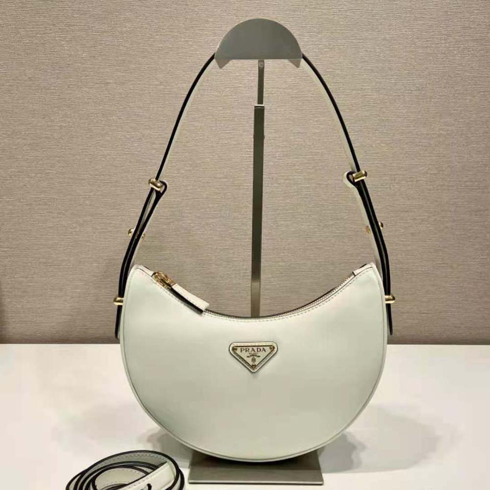 Close-up of enameled metal triangle logo on Prada Women Leather Shoulder Bag