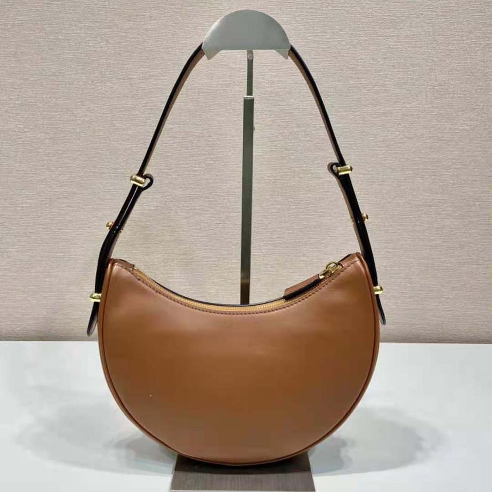 Side angle showing gold hardware and leather texture on Prada shoulder bag