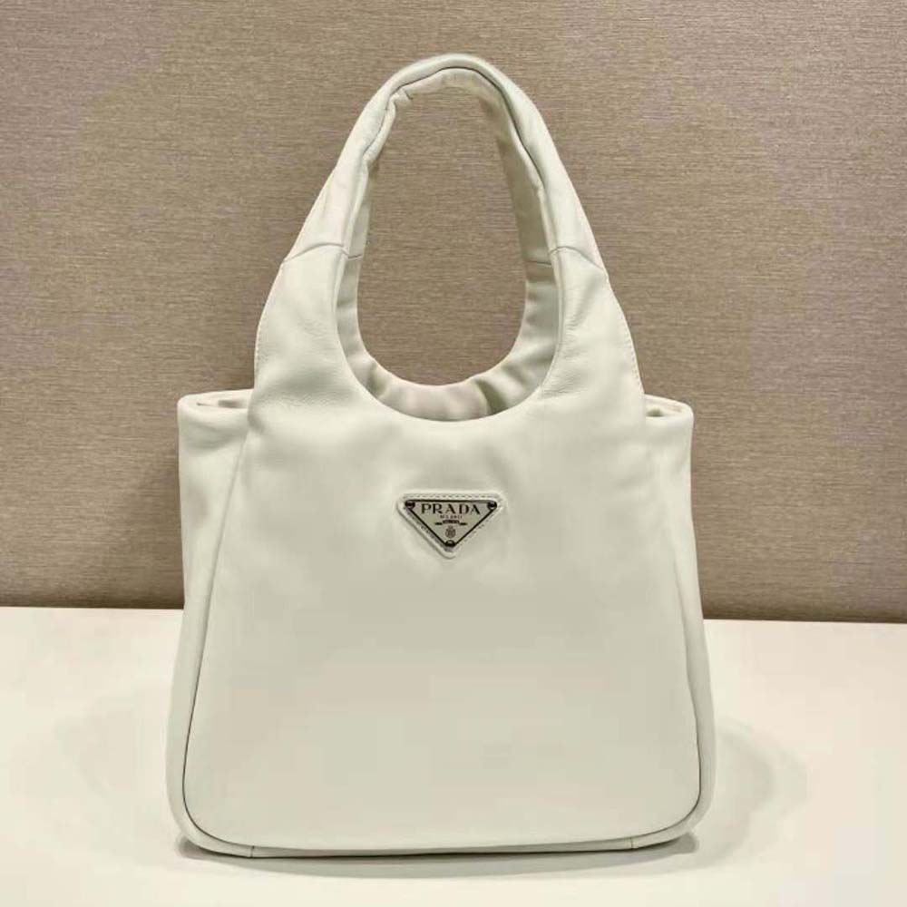 Close-up of silver Prada logo hardware on white nappa leather bag