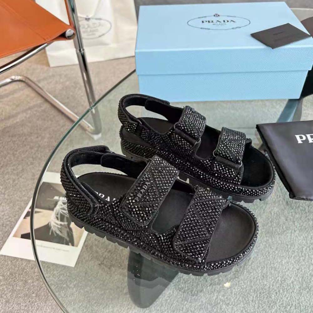 Side angle showcasing heel and satin finish of Prada Women Satin Sandals