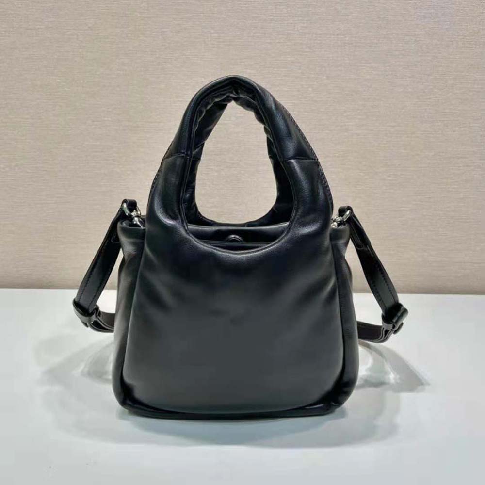 Side angle showing compact silhouette of Prada Women Small Padded Prada Soft Nappa-Leather Bag-Black