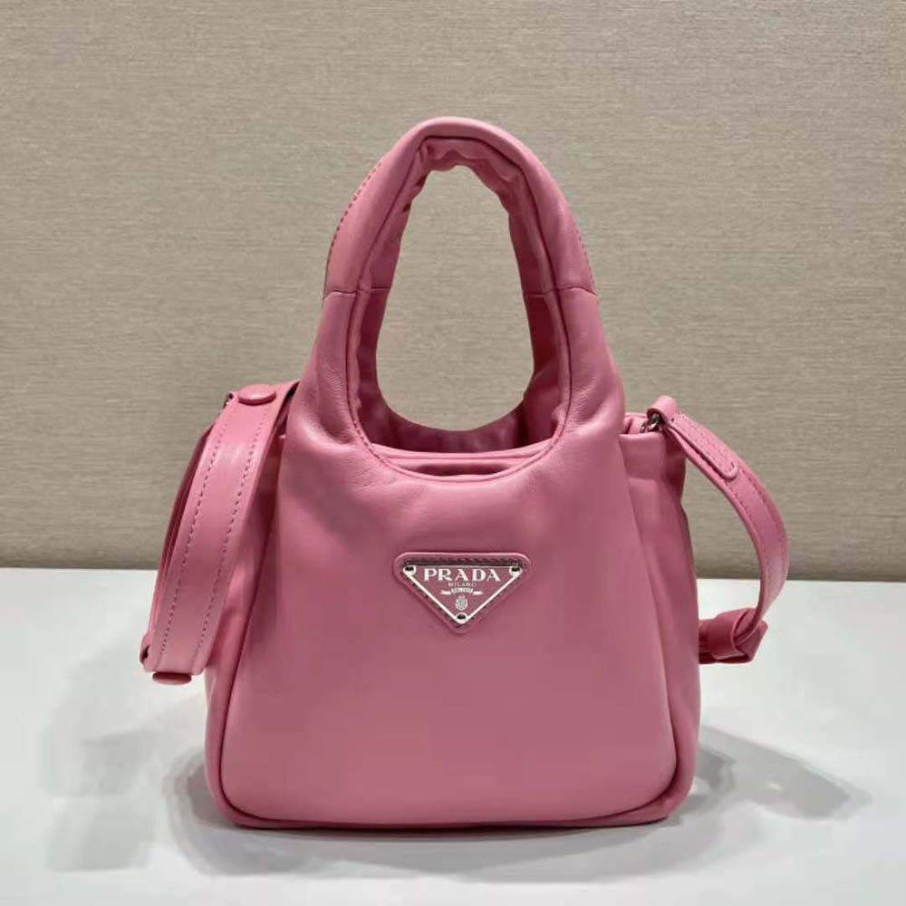 Close-up of padded texture and silver hardware on Prada pink leather bag