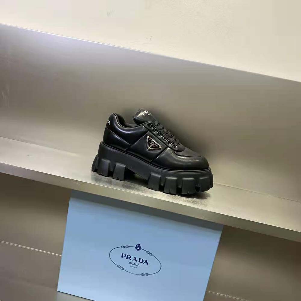 Close-up on black nappa leather and laces of Prada sneakers