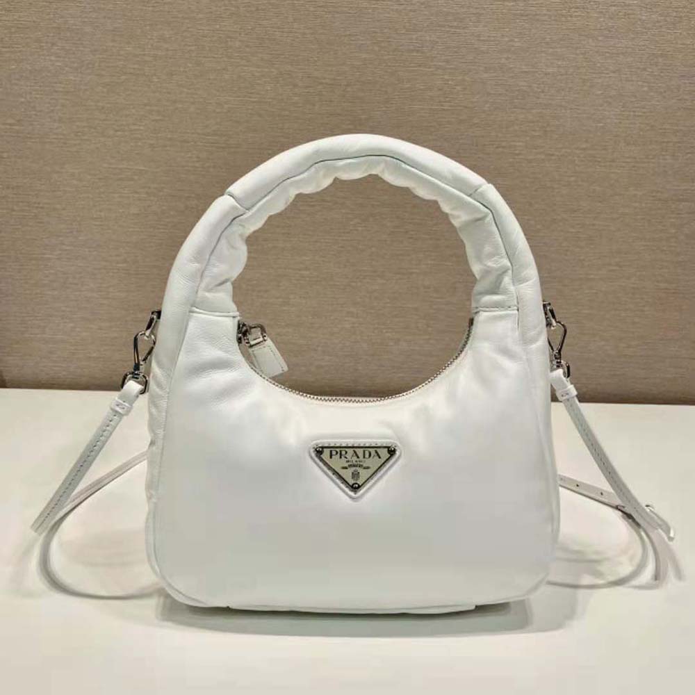 Close-up of Prada logo hardware on white padded nappa leather mini-bag