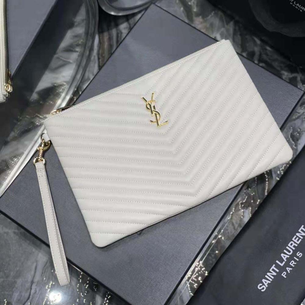 Close-up of quilted leather and gold YSL logo on Cassandre Tablet Pouch