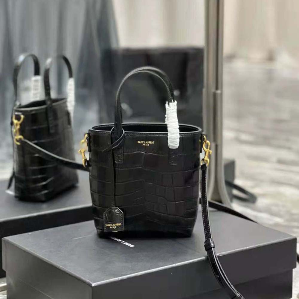 Close-up of crocodile-embossed leather and gold YSL logo detail