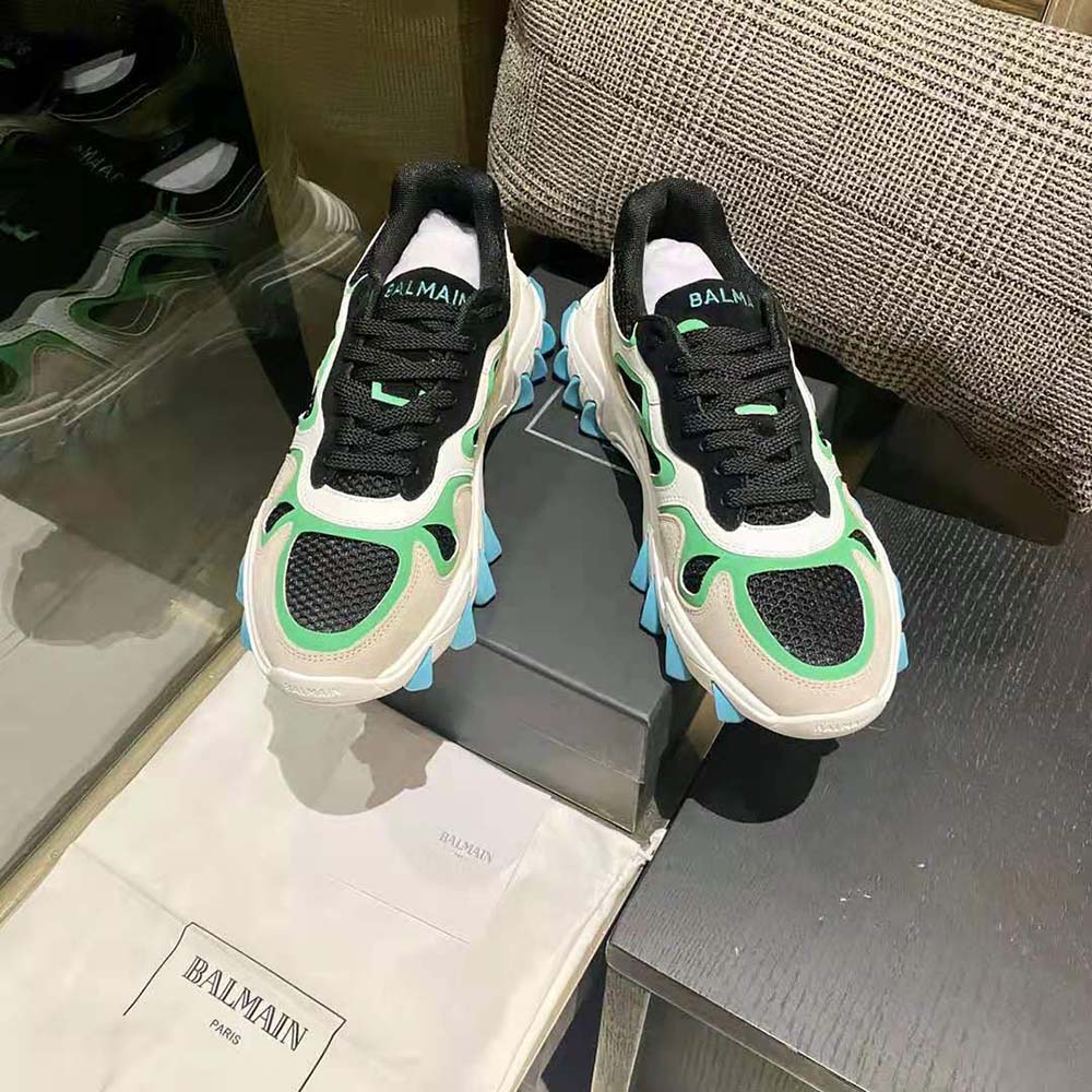 Close-up on Balmain logo hardware on aqua B-East Trainer