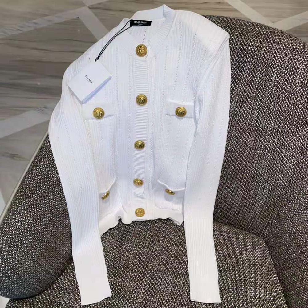 Close-up detail of gold buttons on Balmain Women Knit Cardigan