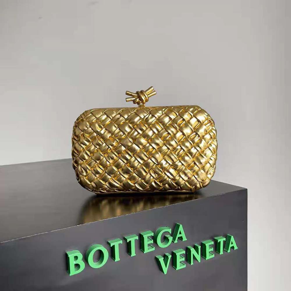 Close-up of gold knot hardware on Bottega Veneta Women Knot Pressed Intreccio Laminated Leather Minaudiere-Gold