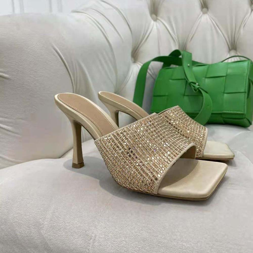 Close-up of gold strass embellishments on Bottega Veneta silk mules