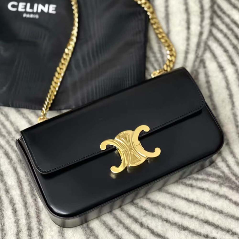 Close-up on signature gold Triomphe chain hardware detail on bag