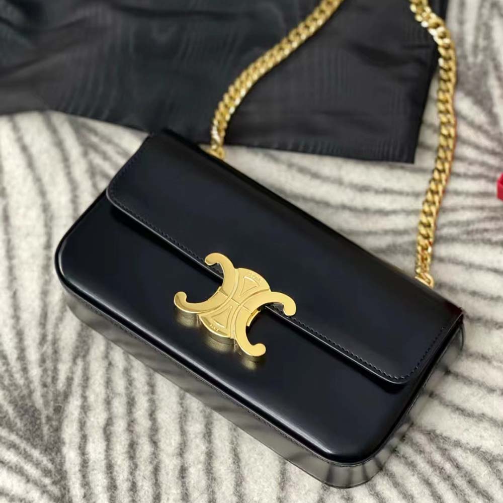 Side angle showing shiny calfskin texture and chain strap of bag