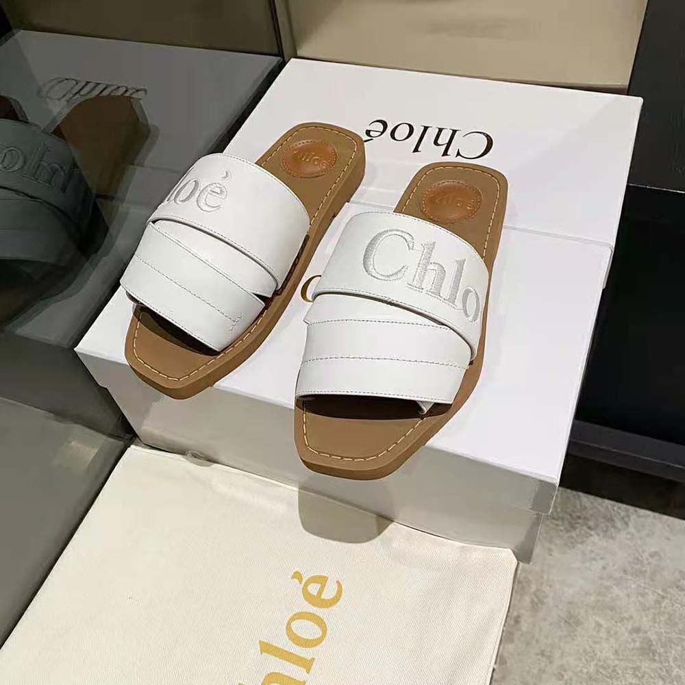 Front angled shot highlighting slip-on design of Chloe Women Woody Flat Mule-White