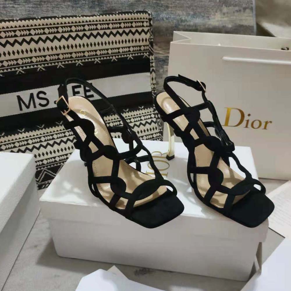 Close-up on Dior logo hardware of black suede D-Fame sandal