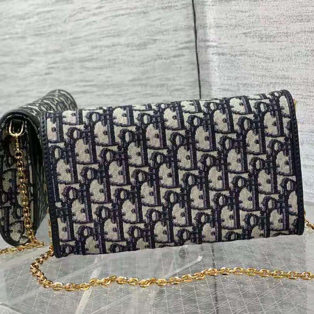 Side angle showing slim profile and zip closure of Dior Women Dior Bobby East-West Pouch
