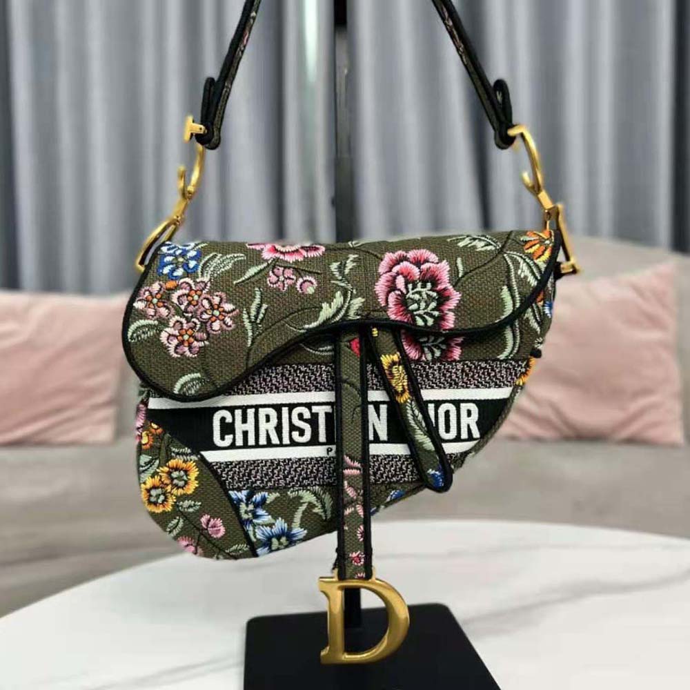 Side angle showing silhouette of Dior Women Saddle Bag with floral detail