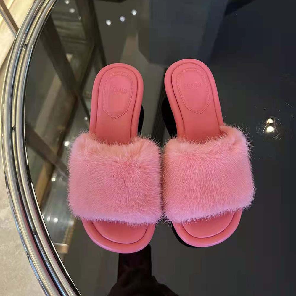 Close-up of pink mink suede and gold hardware on Fendi Women Baguette Slides