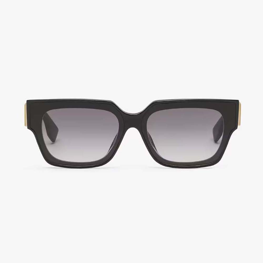 Close-up of gold Fendi logo detail on black acetate sunglasses