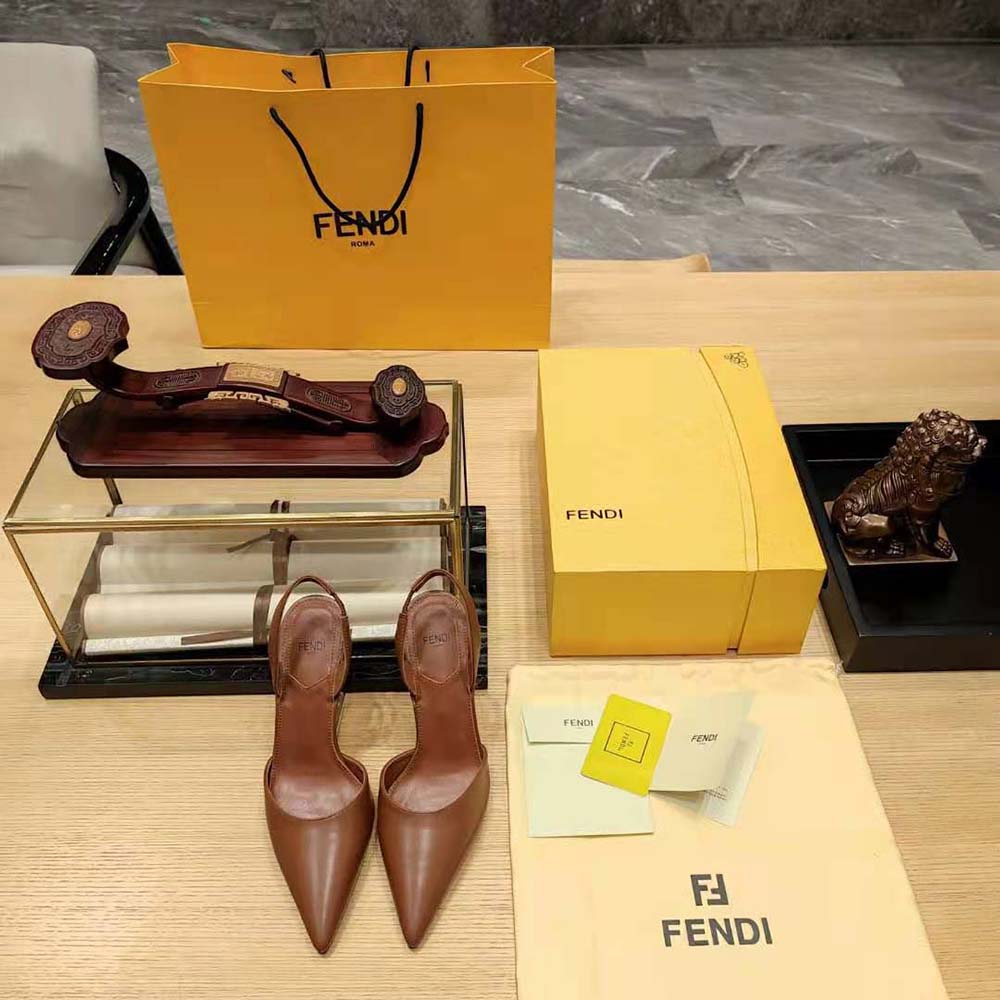 Close-up of gold Fendi logo hardware on slingback strap