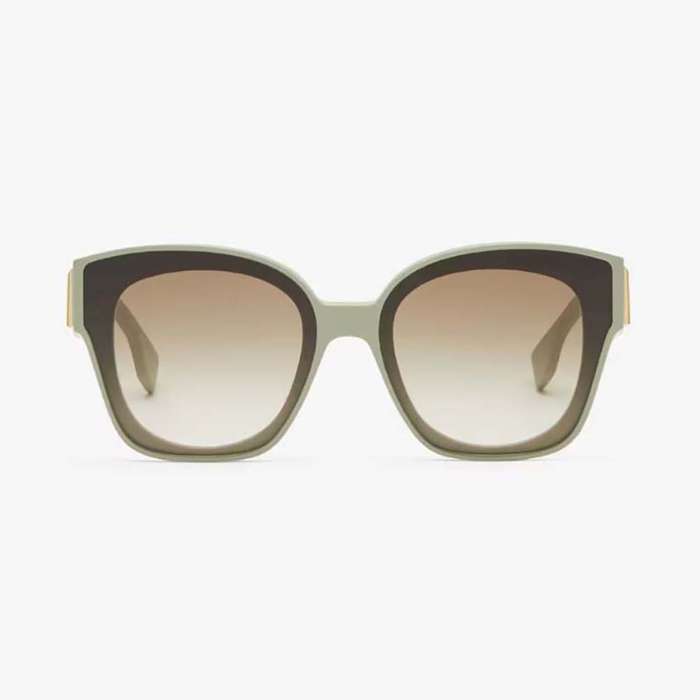 Close-up of gold Fendi hardware on mint green acetate sunglasses
